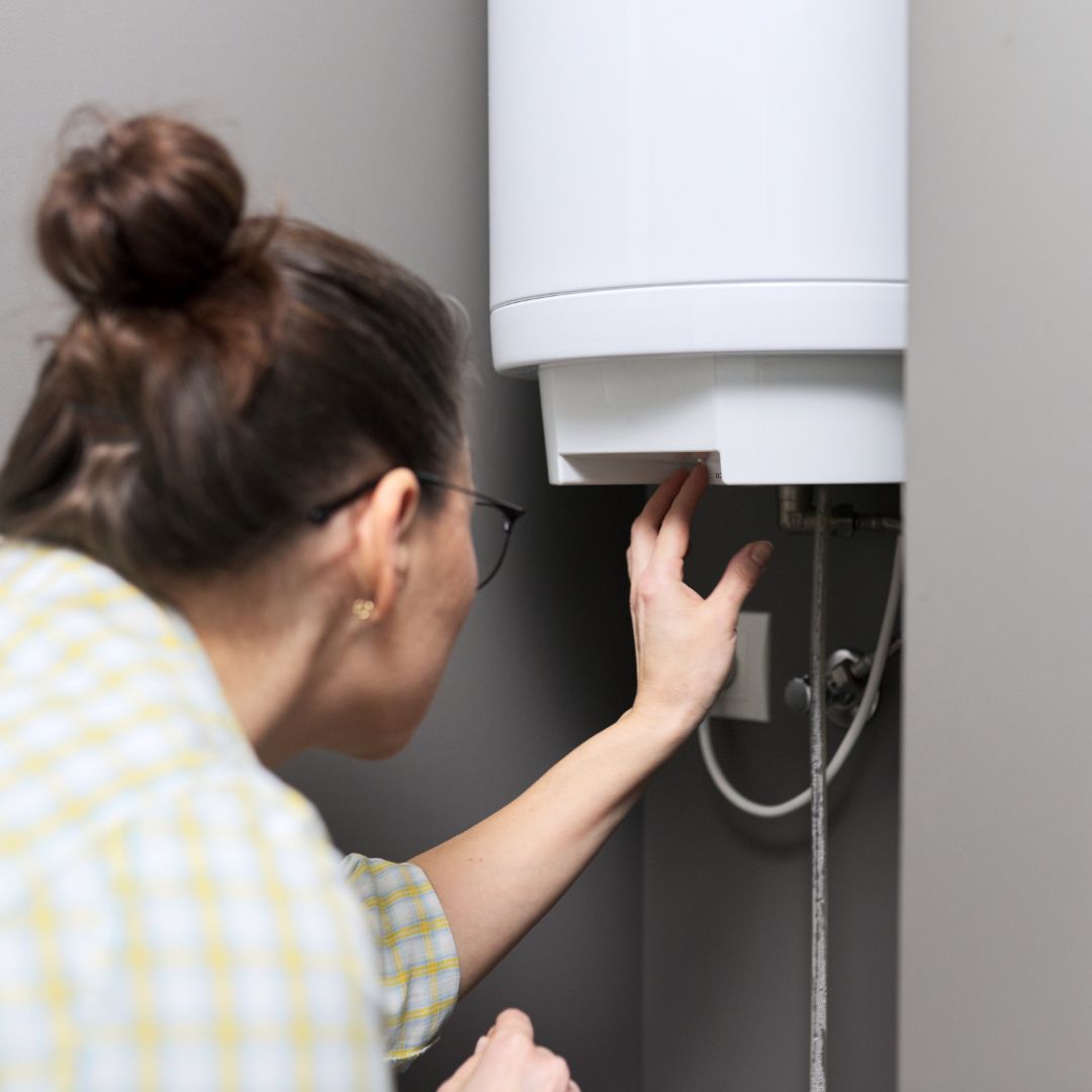 woman looking at water heater