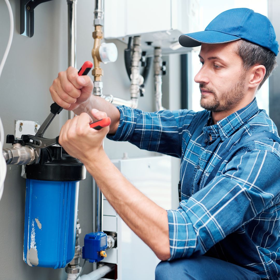 a plumber working on a water filter